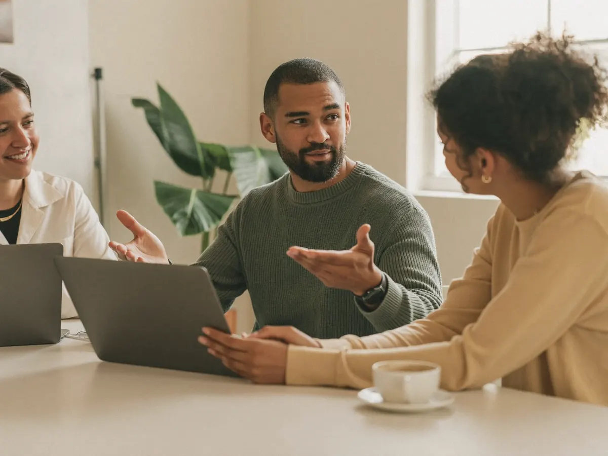 Engineer hired from abroad explaining an idea to two colleagues